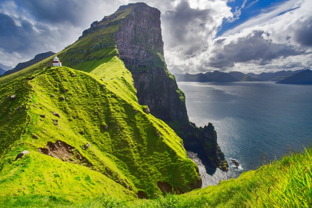 The Kallur Lighthouse perched on the peaks of the Faroe Islands