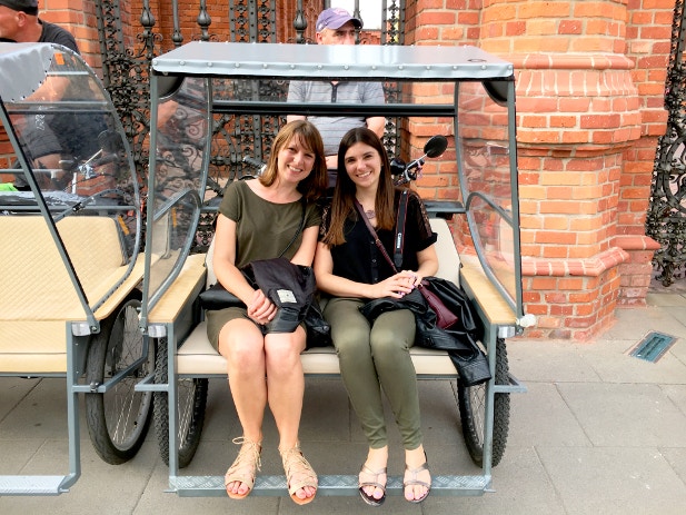 Claire and friend sitting in a pedicab before the start of their tour