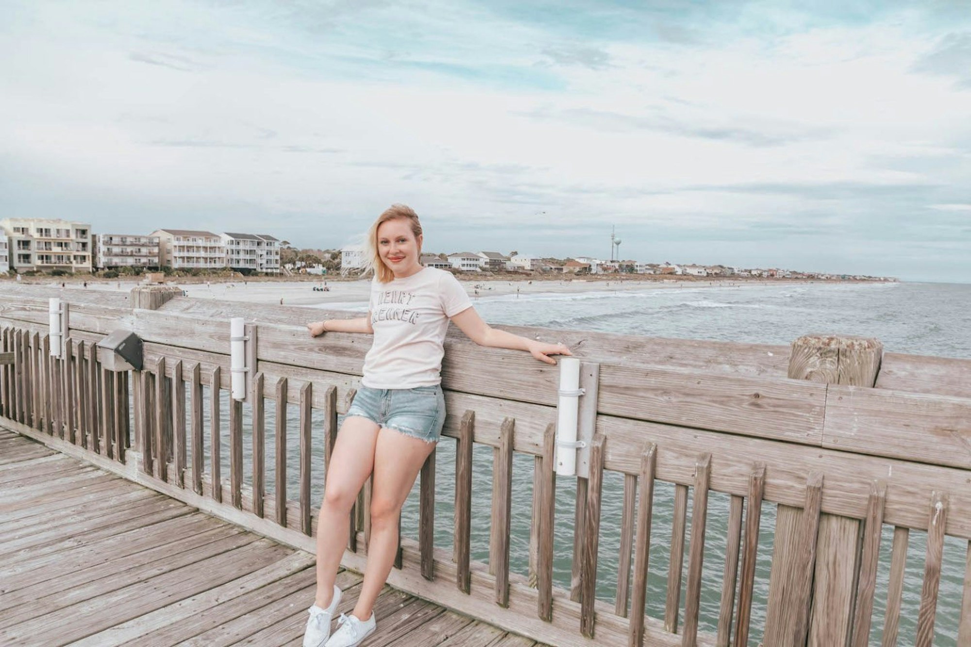 Holly having her photo taken in a wooden pier overlooking the ocean © Holly Habeck