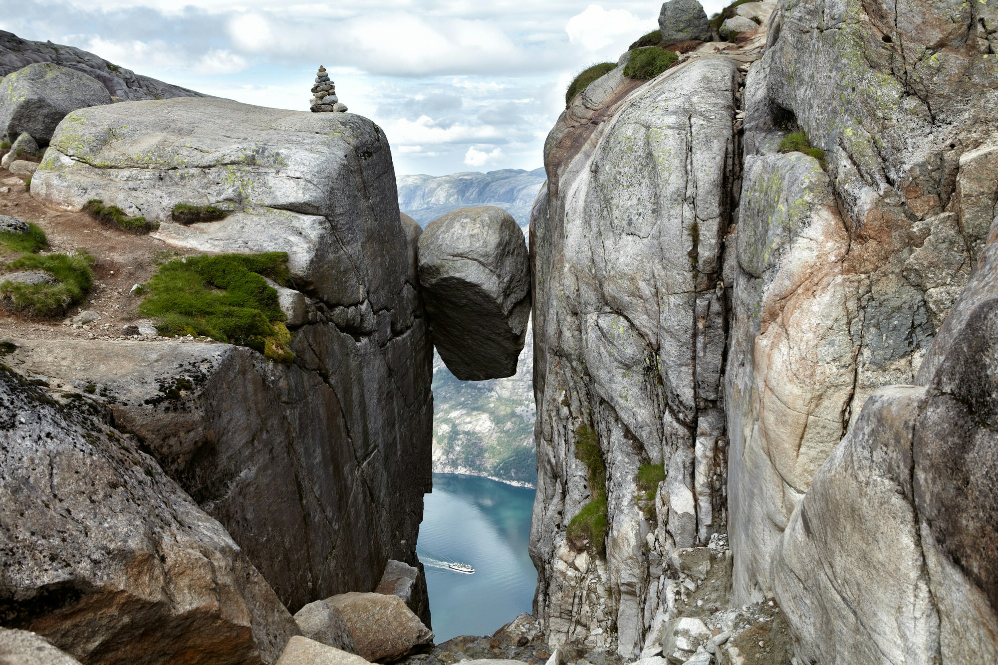 Norway's Kjeragbolten, a boulder precariously wedged in a mountain crevasse, has become a major tourist attraction for daredevils © Beas777 / Shutterstock