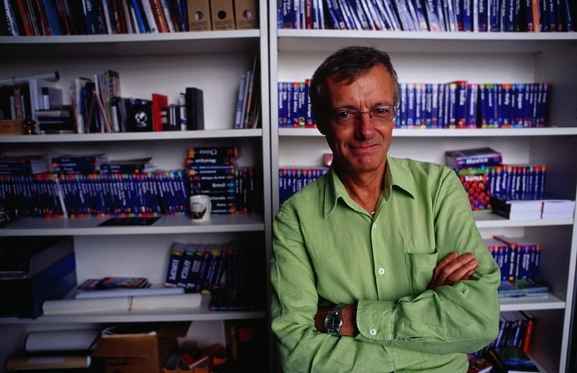 Tony Wheeler in a library of Lonely Planet guides © Lonely Planet