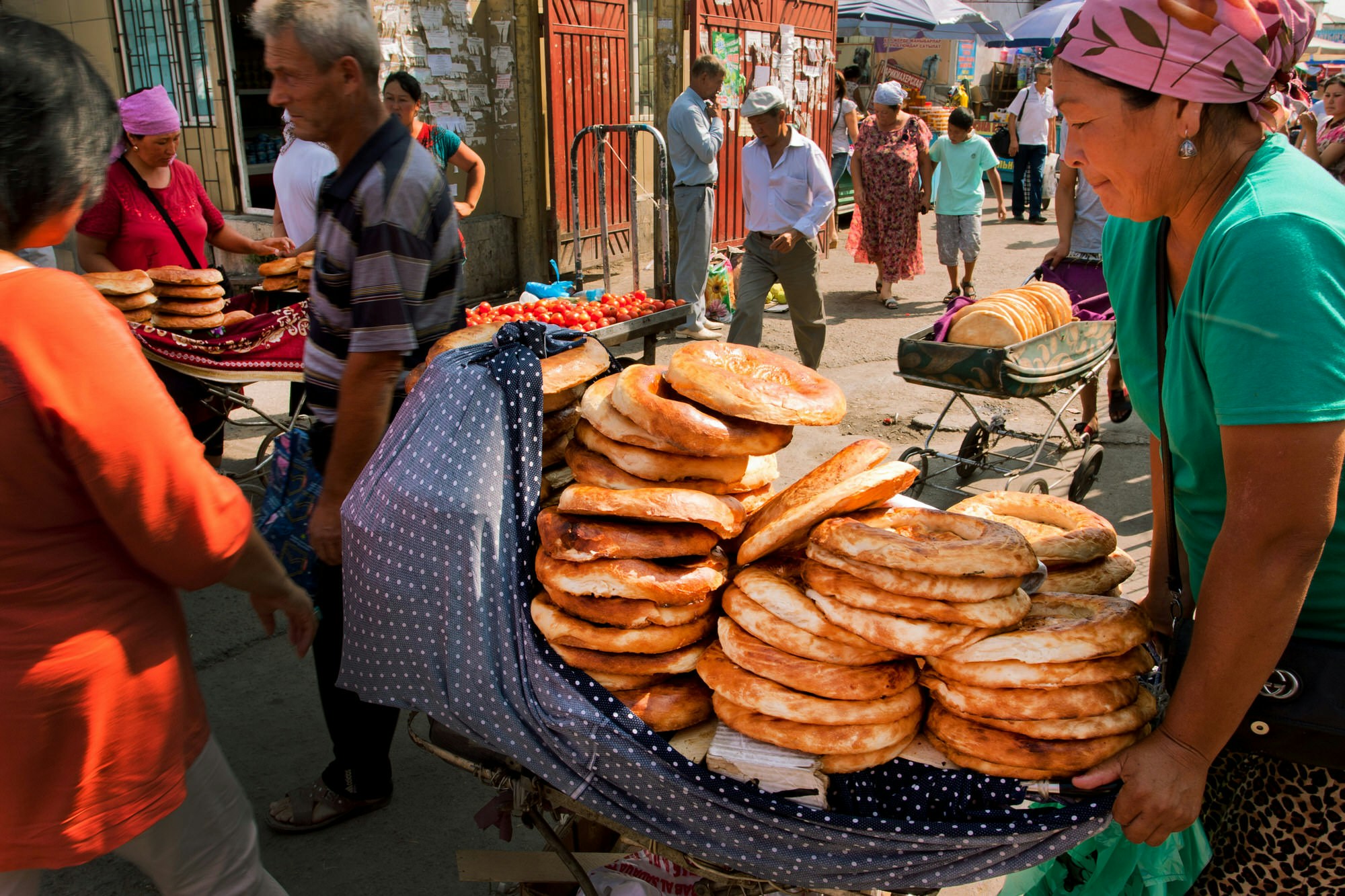 Women selling traditional Central Asian bread at popular Osh market bazaar in Bishkek, Kyrgyzstan