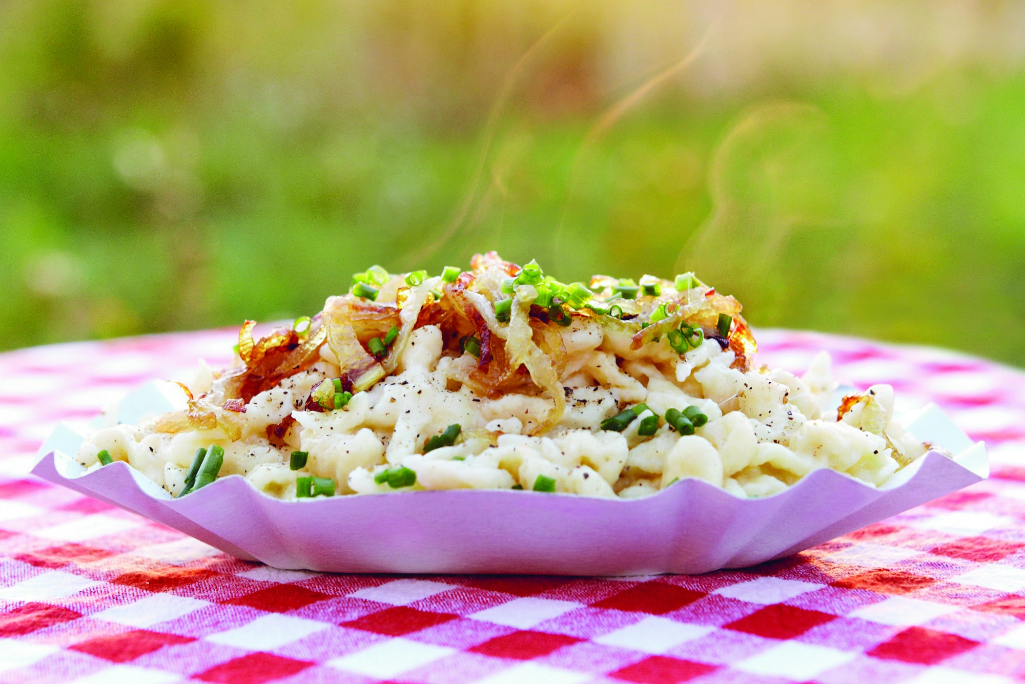 Kässpätzle in a dish on a gingham table cloth
