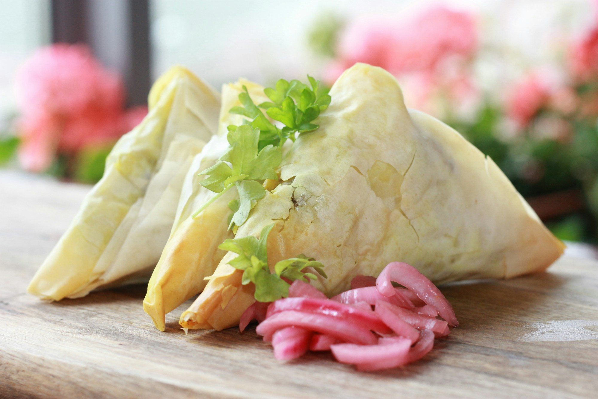 Spicy Killary lamb samosas on a serving board