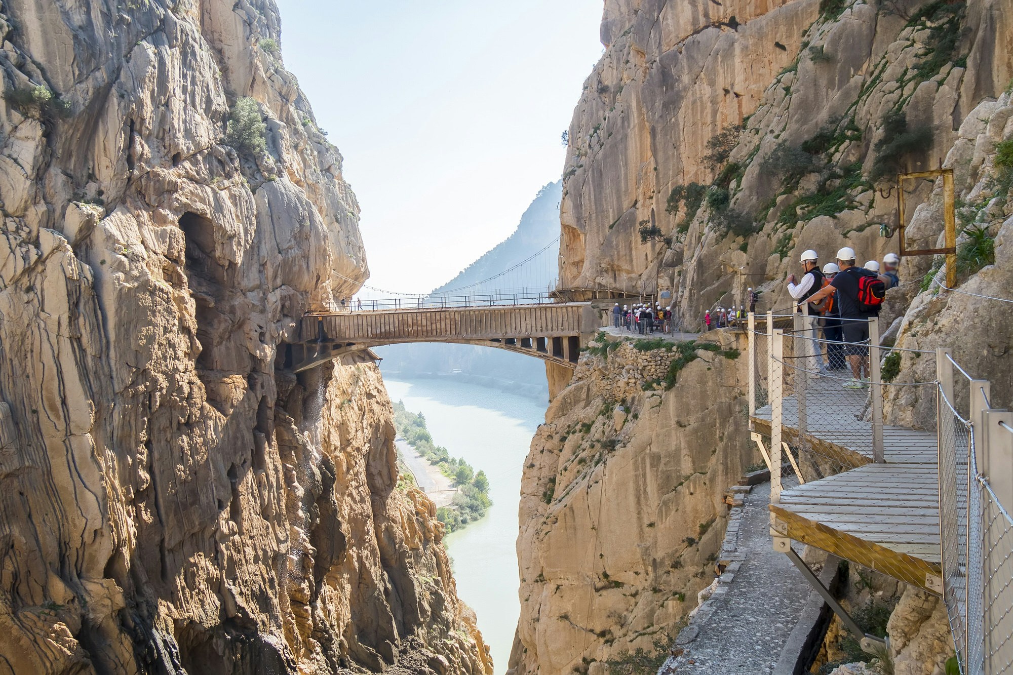 A section of the Caminito del Rey, a narrow wooden walkway protruding from a sheer rock face