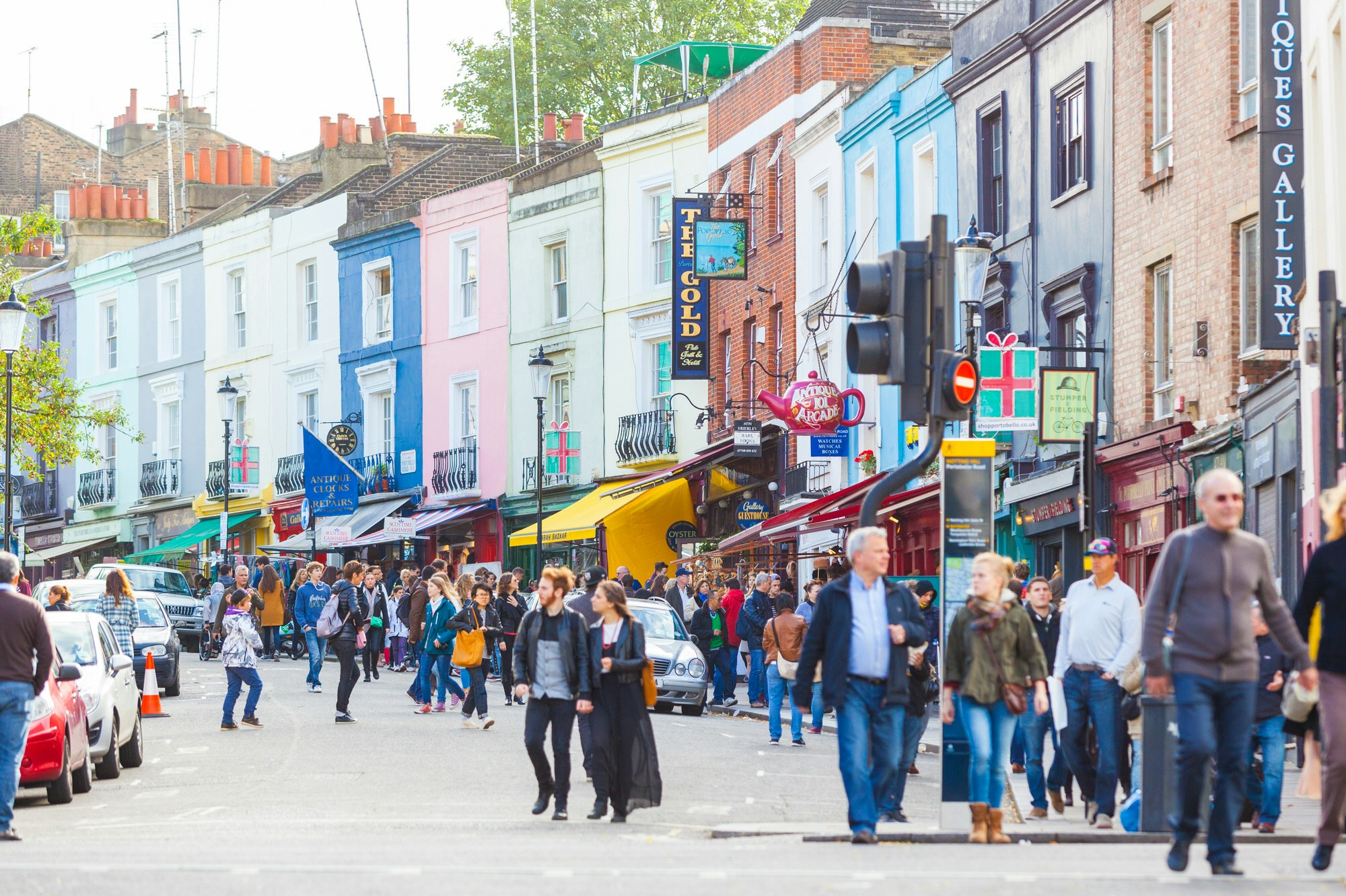 People stroll along London's Portobello Road, a famous market area in Notting Hill district