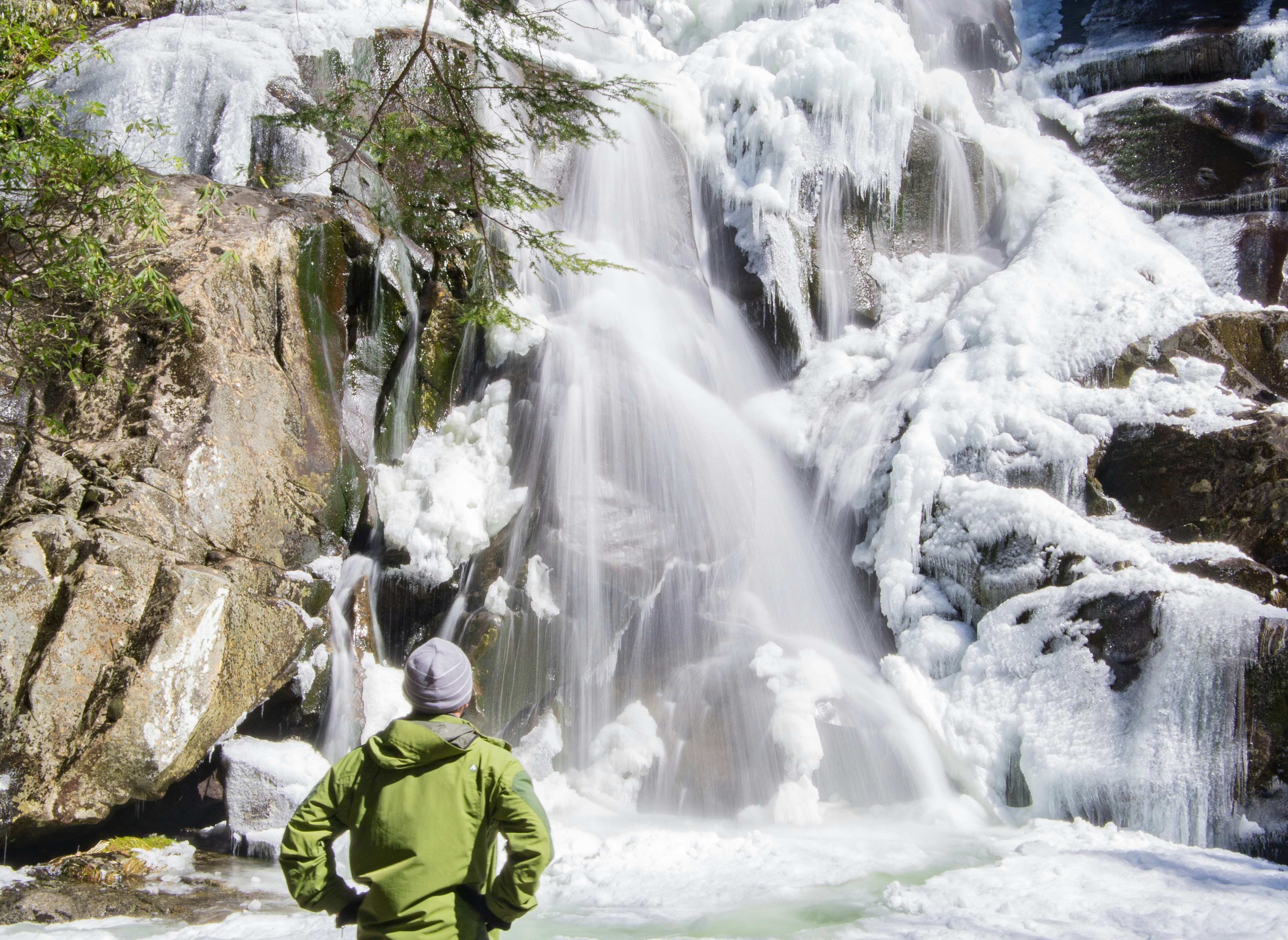 Man stands in front of waterfall in The Great Smoky Mountains National Park